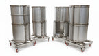 Set of metal drums on wheels in an industrial setting
