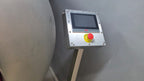 Control panel with a red and yellow button on a gray background